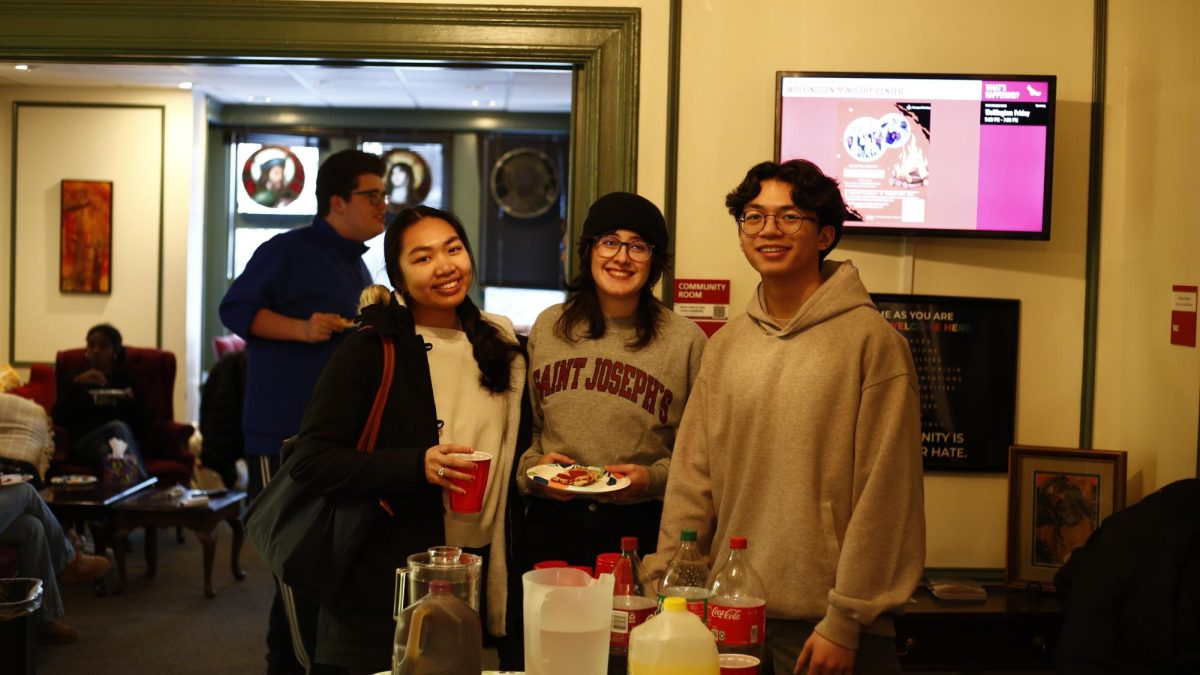From left to right: Kylie Tang ’26, Kate Malley ’27 and Roman Nepomuceno ’29 gather in Wolfington Center for Ministry, Faith and Service for Wolfington Fridays. PHOTO: DEE ALABEDE ’26/THE HAWK